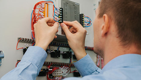 Low Voltage Electrician adjusting wires in Doylestown, Horsham, New Hope, Southampton, Villanova, Yardley, PA, and the Surrounding Areas