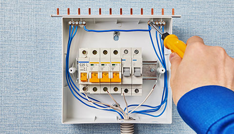 Low Voltage Electrician working on electrical panel in Doylestown, Horsham, New Hope, Southampton, Villanova, Yardley, PA, and the Surrounding Areas